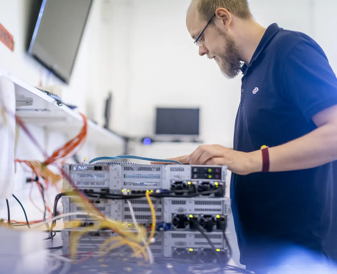 Techincal employee looking at the inside of a computer